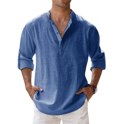 Model wearing the mid-blue Henley shirt with a stand collar, short button placket and rolled sleeves. 2