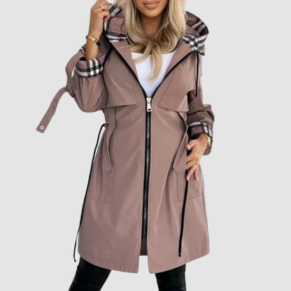 Model wearing the mocha-brown hooded coat unzipped over a white top, showing the checked hood lining, cuffs and waist drawstrings. 1