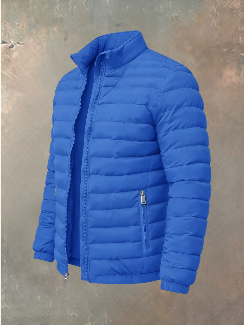 Quilted puffer jacket in bright royal blue, unzipped, shown at an angle against a mottled backdrop 1