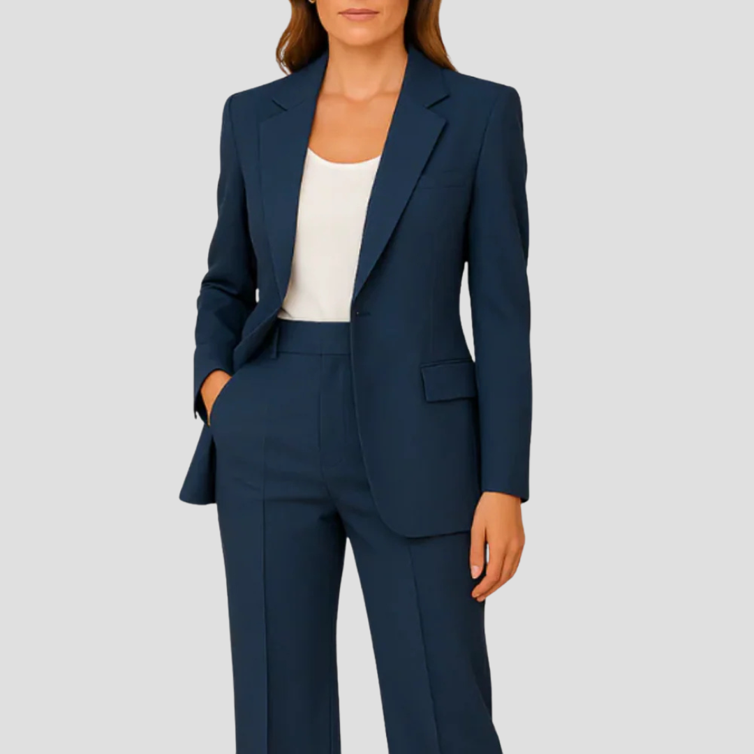 Model wearing the navy suit with a white top, one hand in the trouser pocket 1