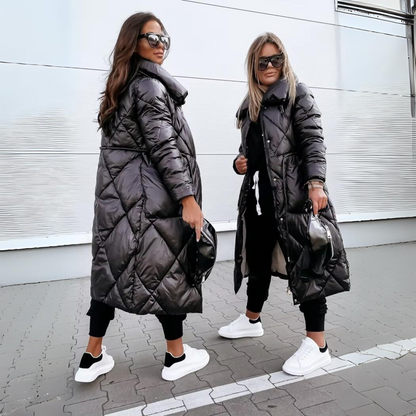 Two women in black quilted long coats, one seen from the side and one from the front, with white chunky trainers. 4