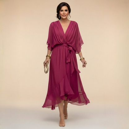 Model wearing the raspberry pink chiffon midi dress with wrap-style V-neck, flutter sleeves, waist tie and tiered ruffle hem. 4