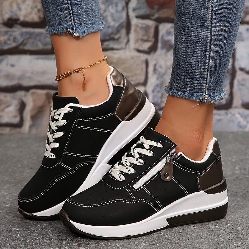 Black version of the lace-up trainers with side zip, worn with a gold anklet against brick 2