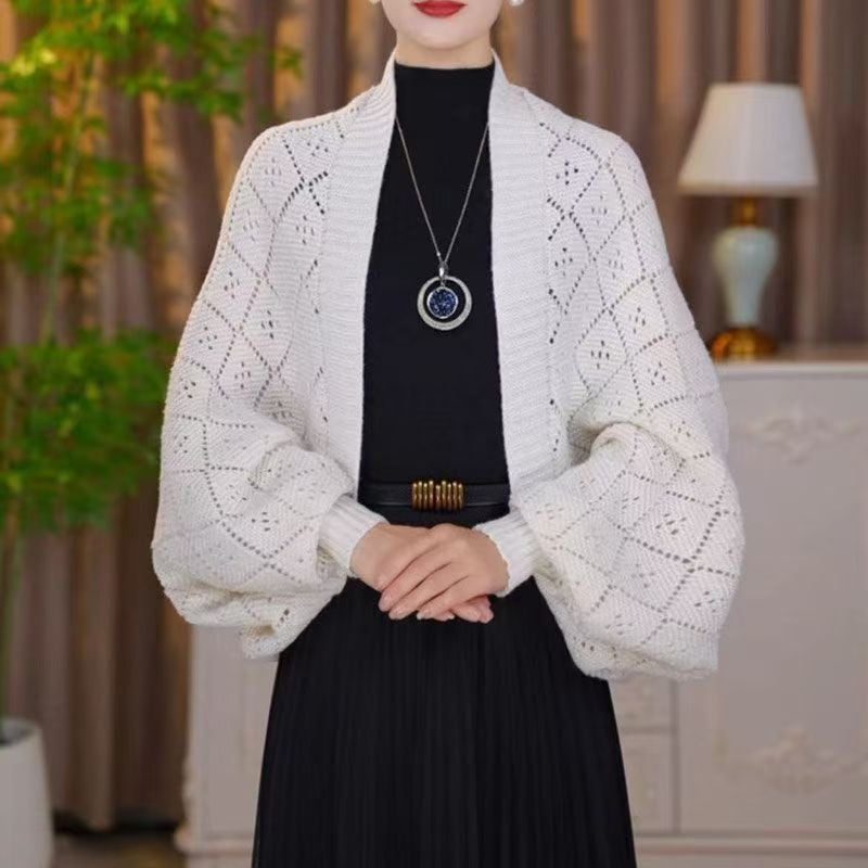Model wearing the open knit shawl cardigan in cream white, showing the diamond openwork pattern on the sleeves 4