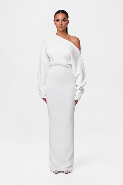Model facing forward in the cream-white off-the-shoulder knit maxi dress with long sleeves and fitted skirt. 6