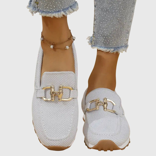 Light grey mesh slip-ons with gold buckle seen from the front, worn with studded jeans 2