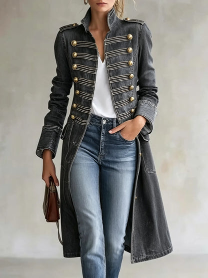Model wearing the coat in a washed charcoal grey version with gold buttons and braiding, styled with a white top and jeans. 10