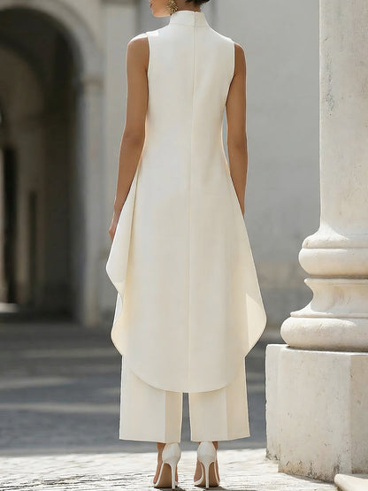 Back view of the cream set on a model, showing the plain back of the top with its centre seam and curved, longer hem. 13