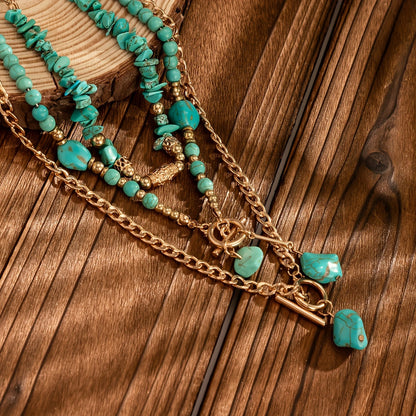 Close-up of the layered necklaces resting on dark wooden planks, showing chips, round beads and nugget pendants 4