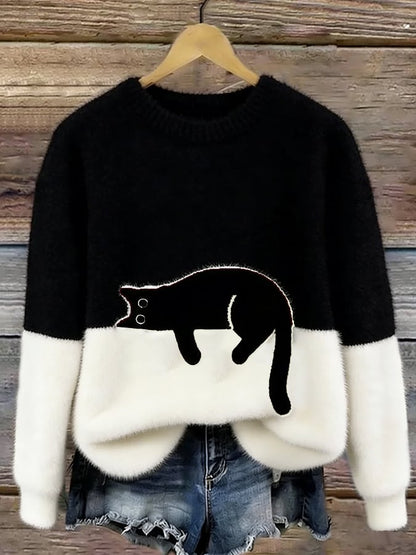 Black and white colour-block fluffy jumper on a hanger, with the black cat outlined by a thin pale edge. 6