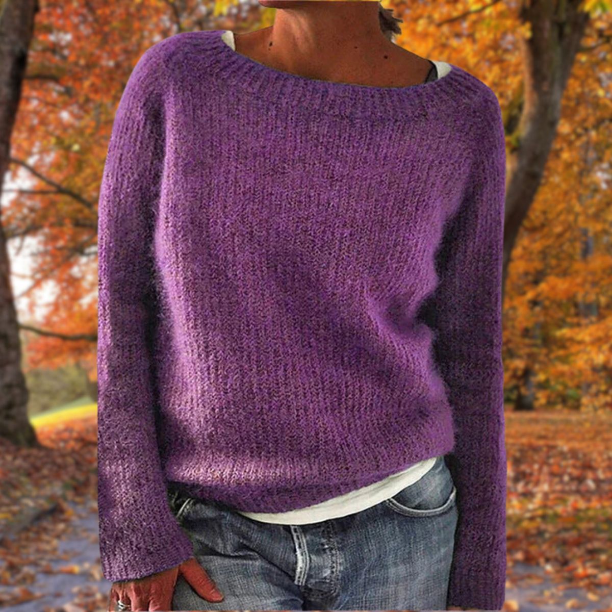 Purple knit sweater with a wide neckline, worn over a white top and jeans in an autumn setting 7