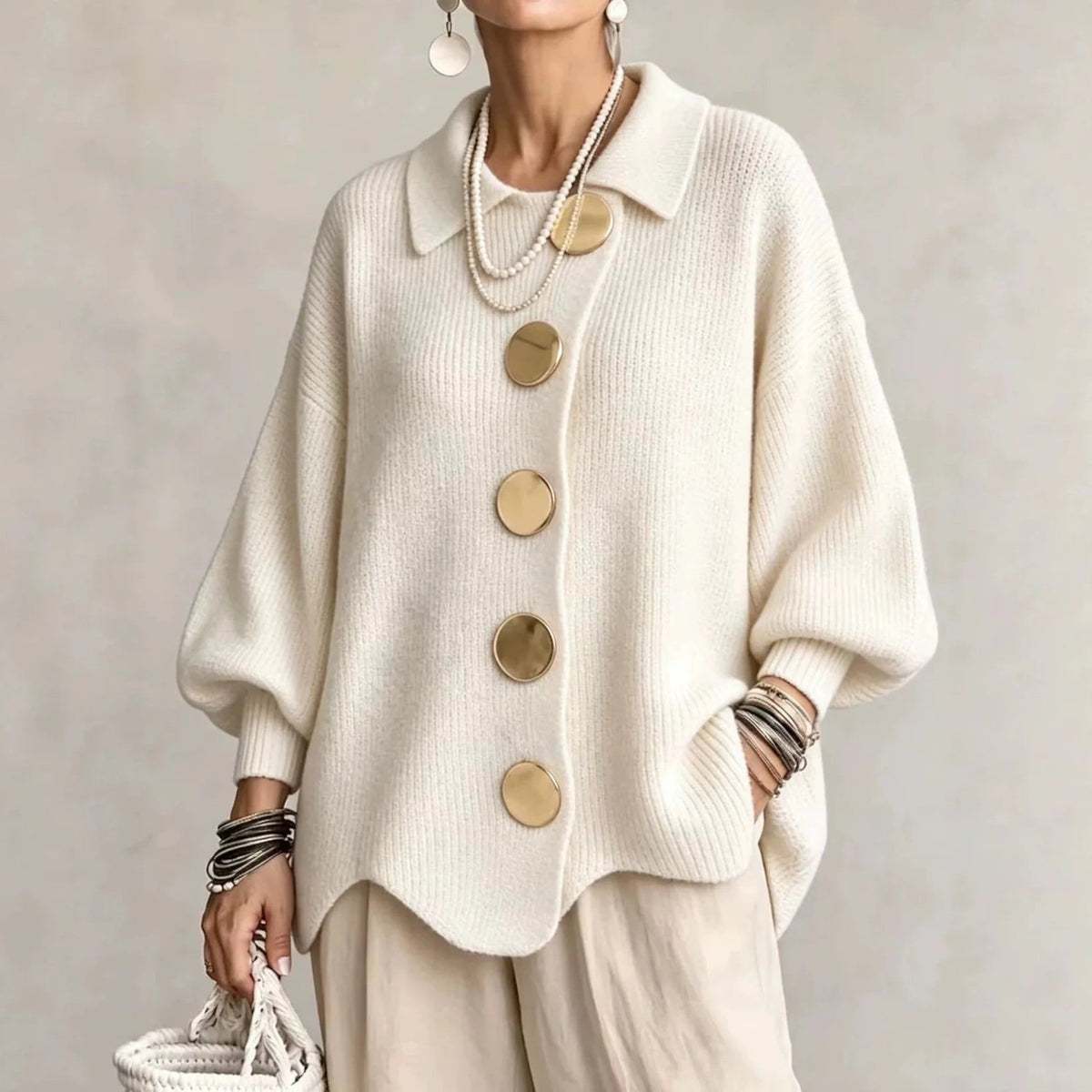 Cream version worn with beige trousers, showing five gold buttons down an asymmetric placket 4