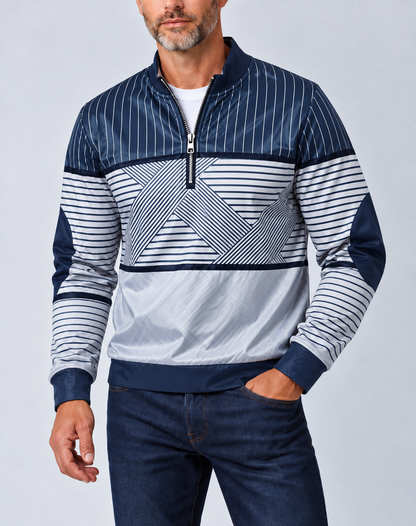 Bearded man wearing the navy and white striped half-zip jumper with dark jeans, hand in pocket 1