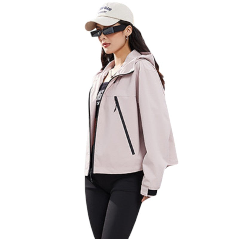 Side view of the dusty pink jacket worn open over a black top, showing the slanted zip pocket and hood. 11