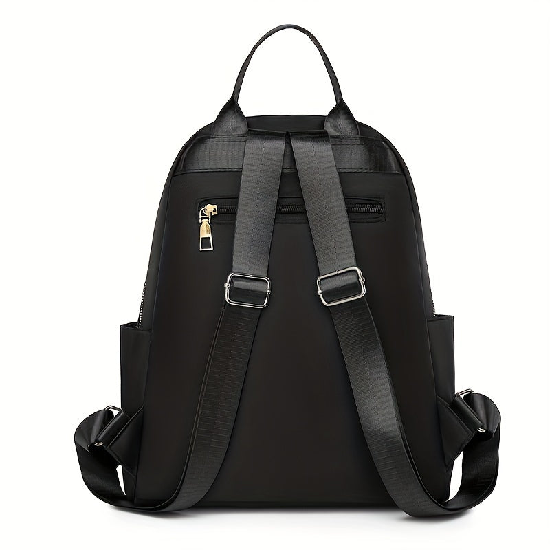 Back of the black backpack showing the adjustable padded shoulder straps, top handle and zipped hidden pocket 7