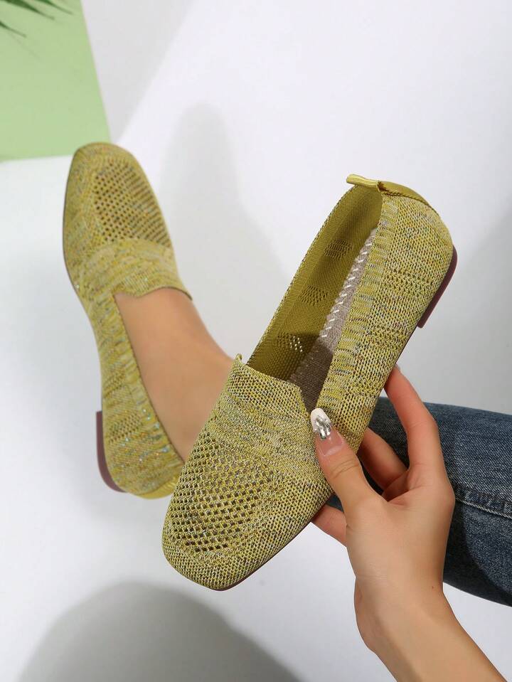 Olive-green mesh slip-ons, one held in hand to show the inside and cushioned footbed, the other worn. 19