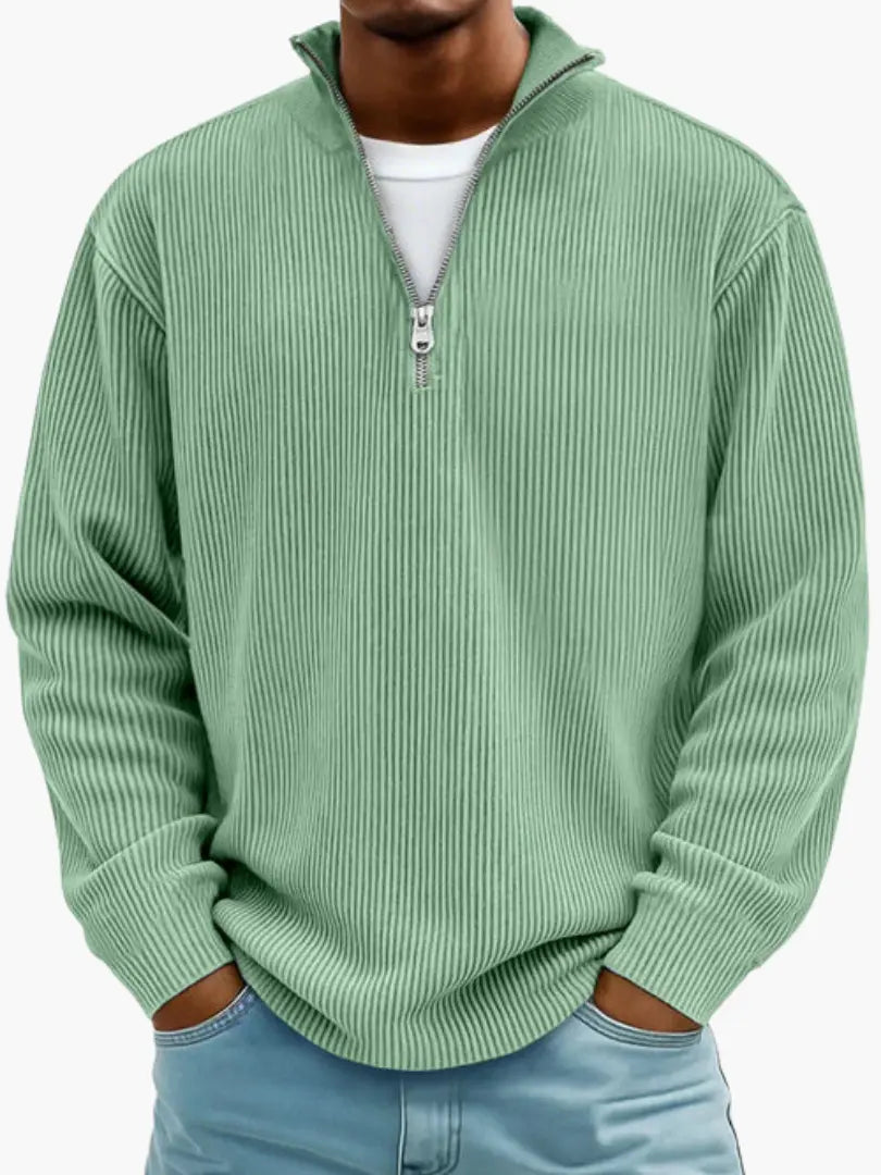 Man wearing the ribbed quarter-zip jumper in soft mint green over a white tee, with hands in his jeans pockets. 3