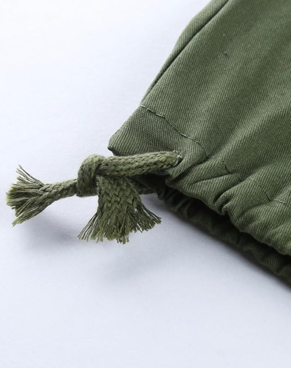 Close-up of the olive green trouser hem, showing the knotted drawcord with frayed ends and the gathered fabric. 12