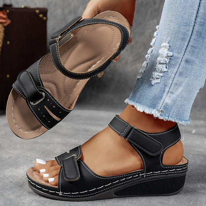 Black wedge sandals with white stitching, one worn by a model and the other held up to show the insole. 4