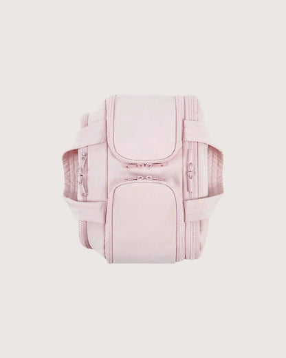 Pink bag seen from above on a plain background, showing its zipped compartments and padded handles folded down on either side. 9