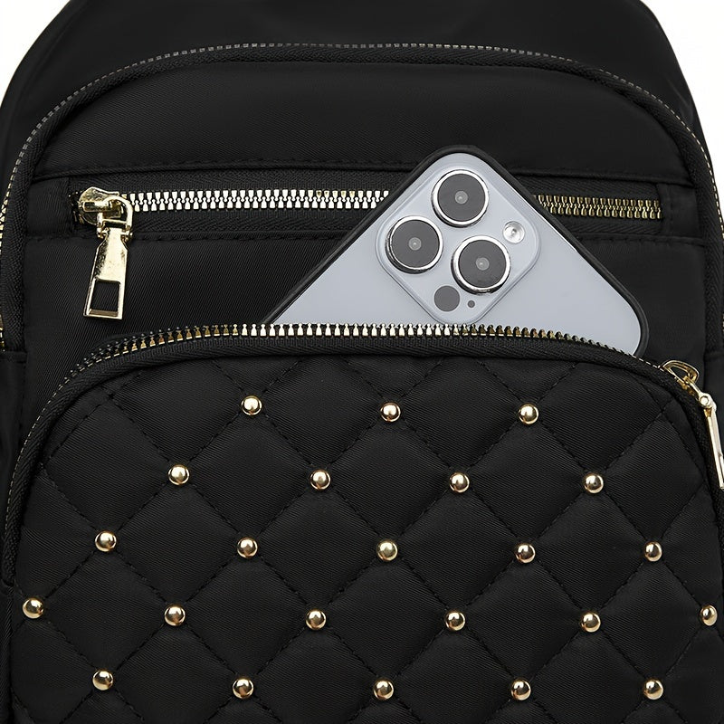 Close-up of a phone tucked into the front zipped pocket above the studded quilted pocket 11