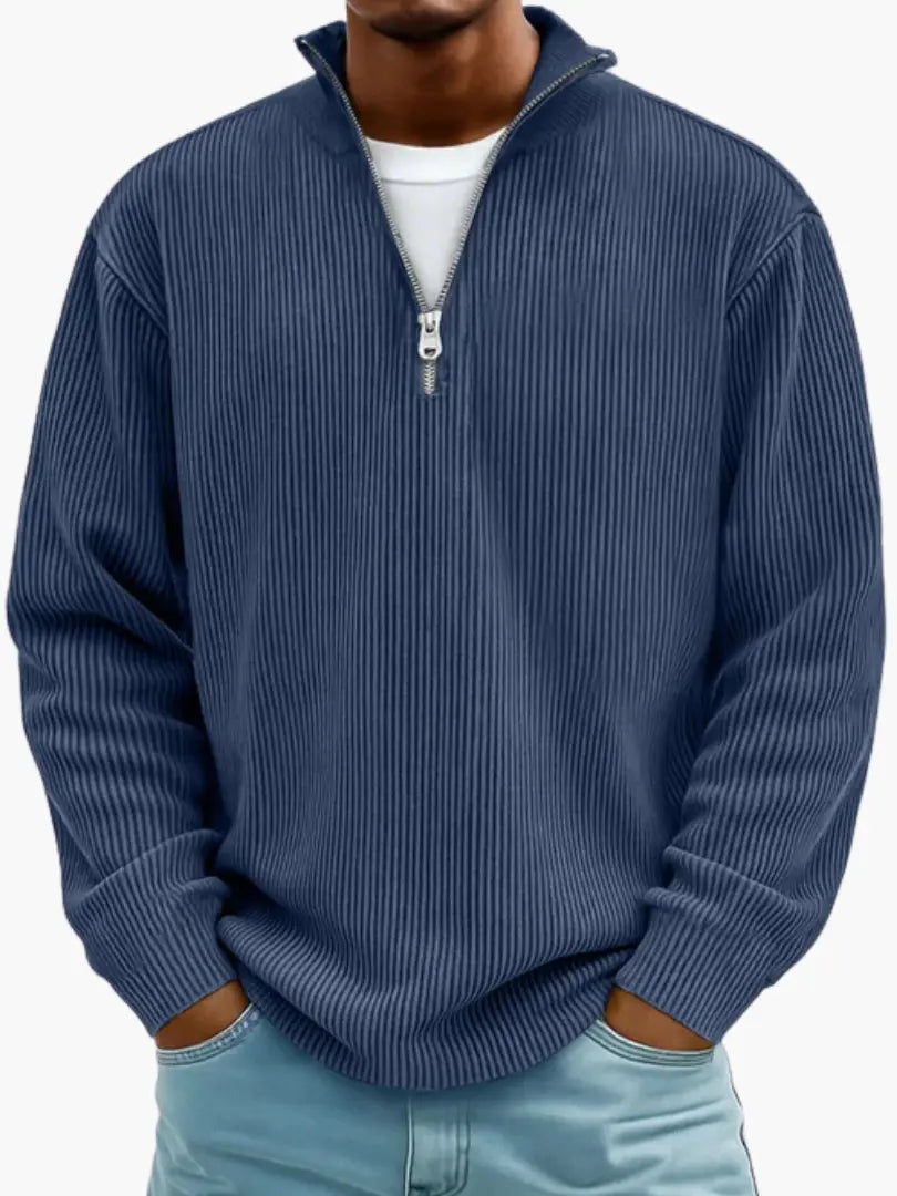 Man wearing the ribbed quarter-zip jumper in navy blue over a white tee, hands resting in his jeans pockets. 5