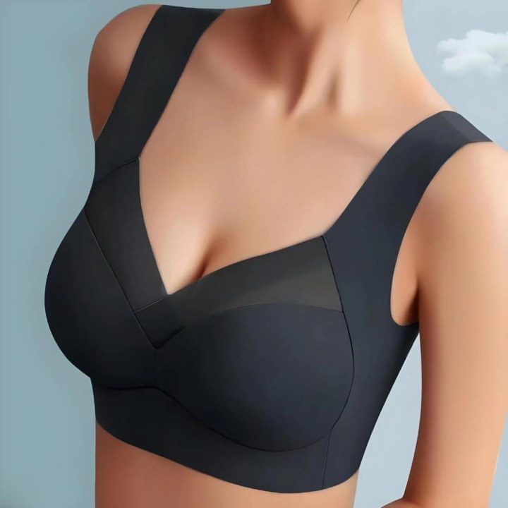 Model wearing the black bra from the front, showing the smooth cups, V-shaped mesh panel and wide straps. 6