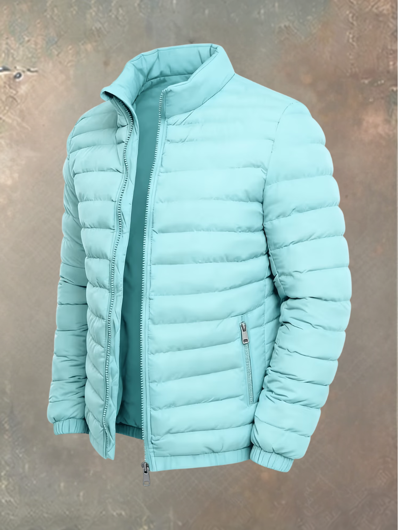 Quilted puffer jacket in pale aqua, angled view showing the stand-up collar and zipped pocket 4