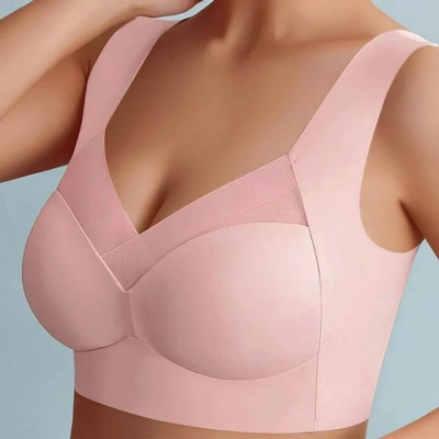 Model wearing the seamless bra in soft pink, close-up of the mesh V panel and smooth cups 2