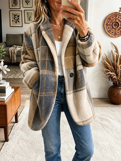 Model wearing the textured fluffy coat in a muted grey, camel and cream check, open over a white top and jeans. 6