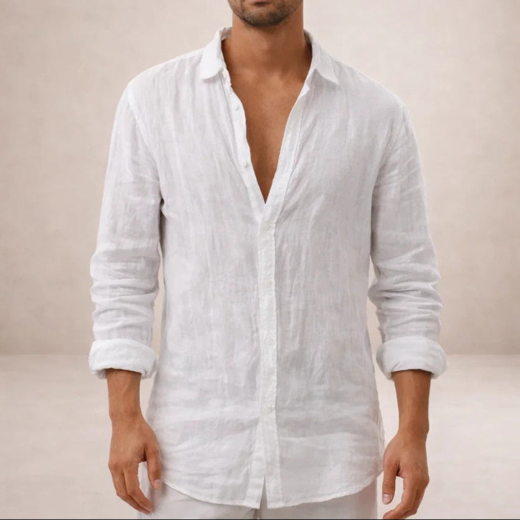 Close-cropped front view of a white linen shirt worn open at the collar, with sleeves rolled to the forearm. 3