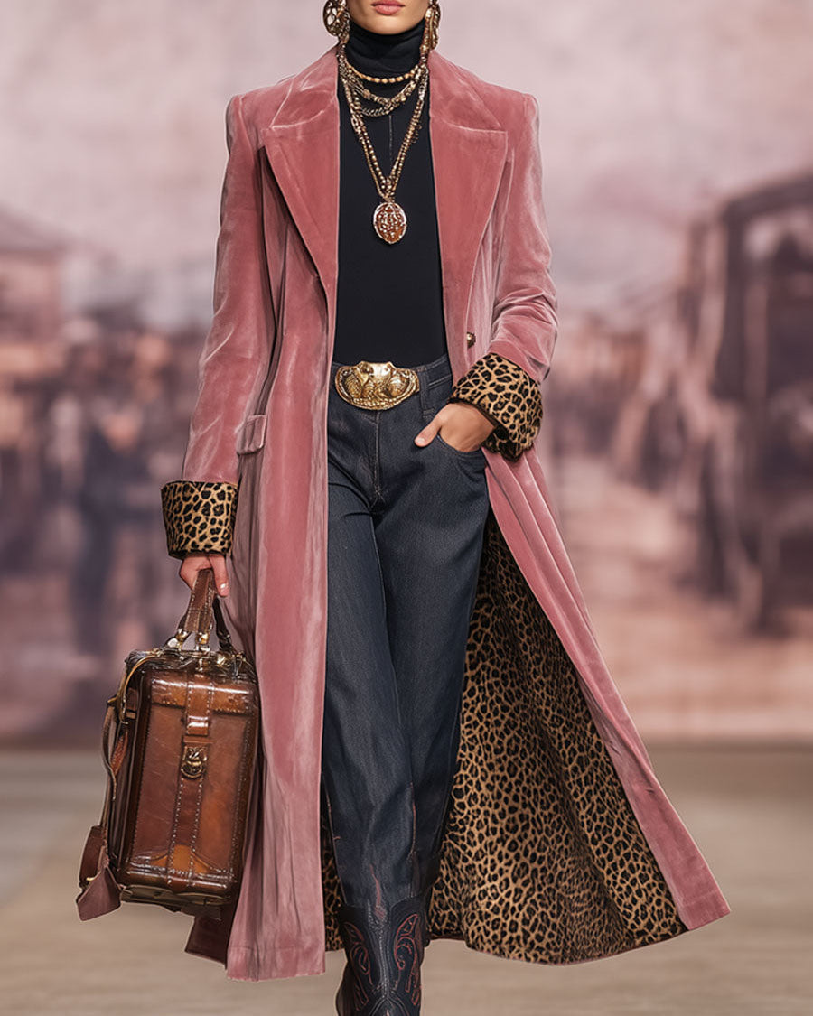 Model on a runway with a blurred street backdrop, holding a brown leather bag, coat worn open 3