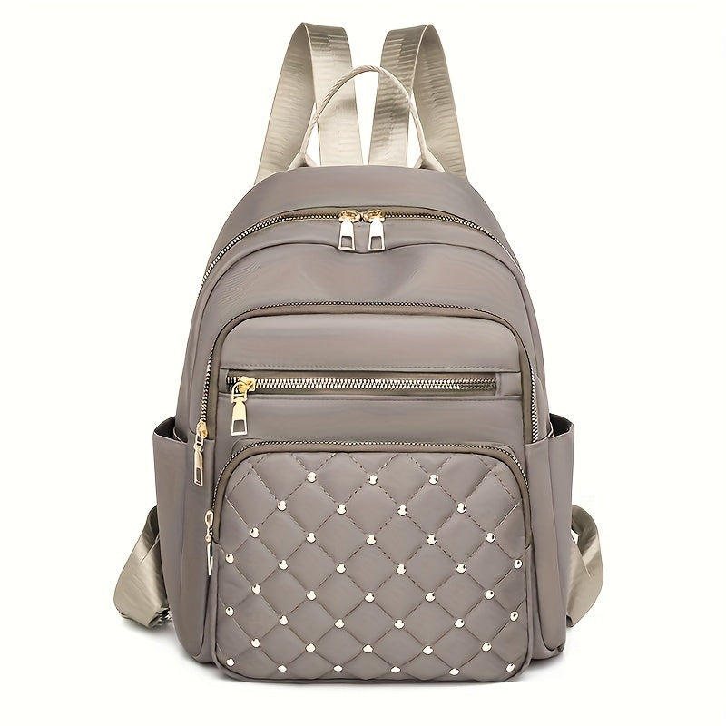 Taupe backpack front view with a quilted, gold-studded front pocket and gold zips 17