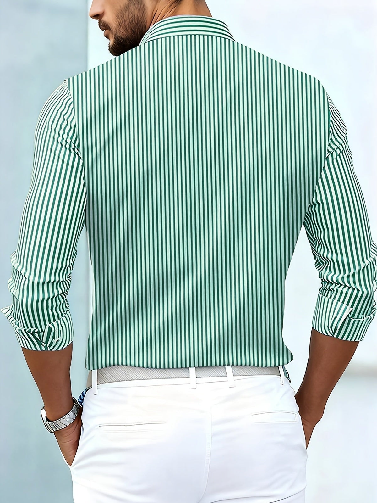 Back view of the green and white striped shirt on a model, showing plain vertical stripes across the back and sleeves. 5