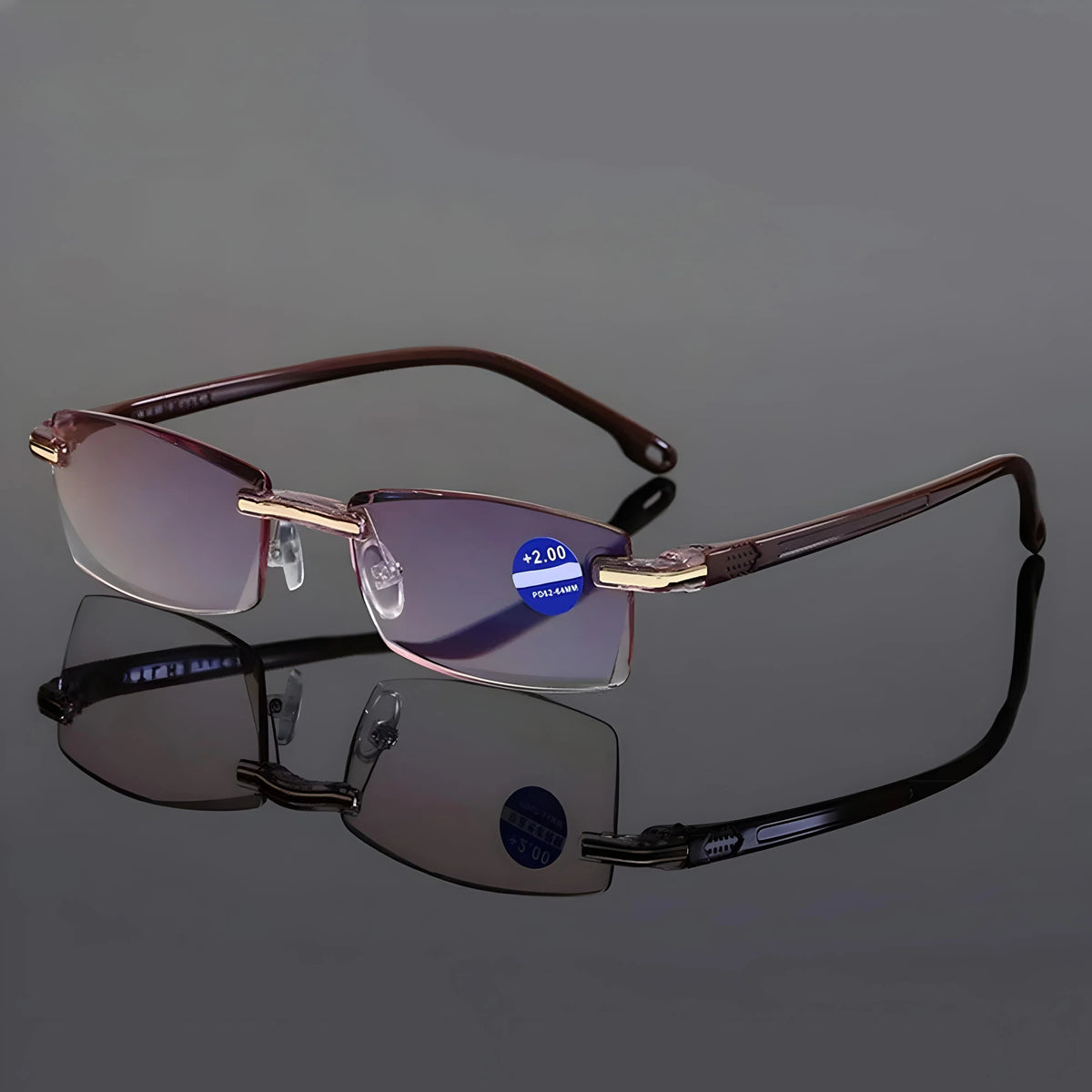 Rimless glasses with brown arms standing open on a reflective grey surface, with a strength sticker on one lens. 7