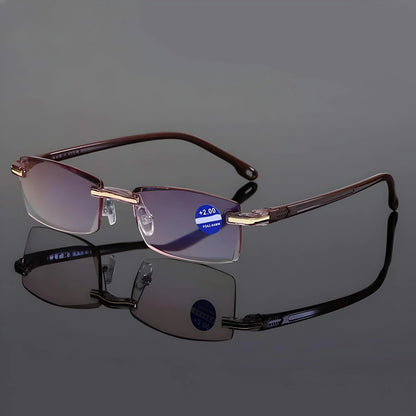 Rimless glasses with brown arms standing open on a reflective grey surface, with a strength sticker on one lens. 7