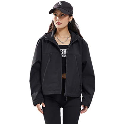 Black jacket worn unzipped over a dark top, front view, with black cap and necklace 15