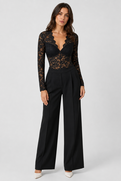 Full-length front view of the black lace bodysuit worn with wide-leg black trousers and white heels 2
