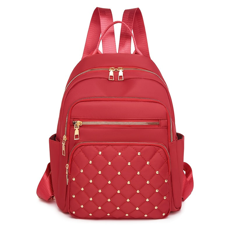 Red backpack front view with a quilted, gold-studded front pocket and gold zips 16