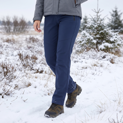 Navy trousers worn by a walker in hiking boots across a snowy heathland 1