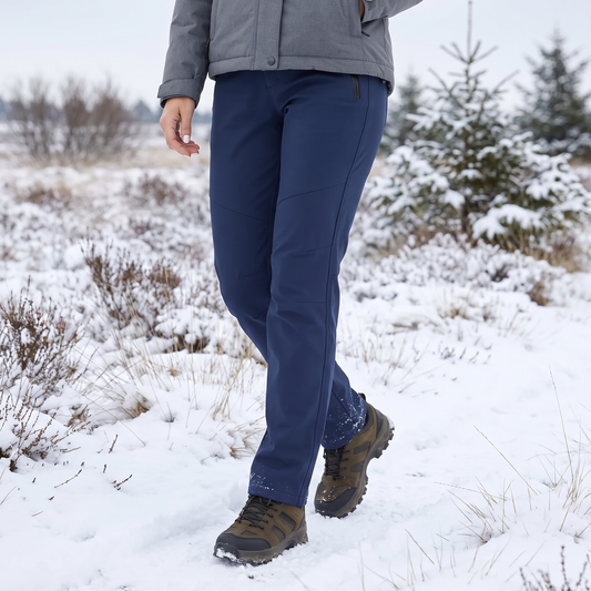 Navy trousers worn by a walker in hiking boots across a snowy heathland 1
