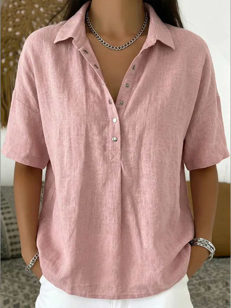 Short-sleeved blouse in dusty pink, worn by a model with a chain necklace and white trousers 5