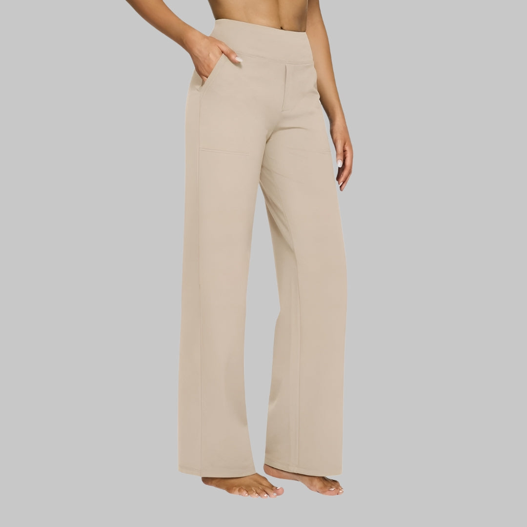 Side view of the high-waist straight-leg trousers in light beige, worn by a barefoot model with a hand in the pocket. 7