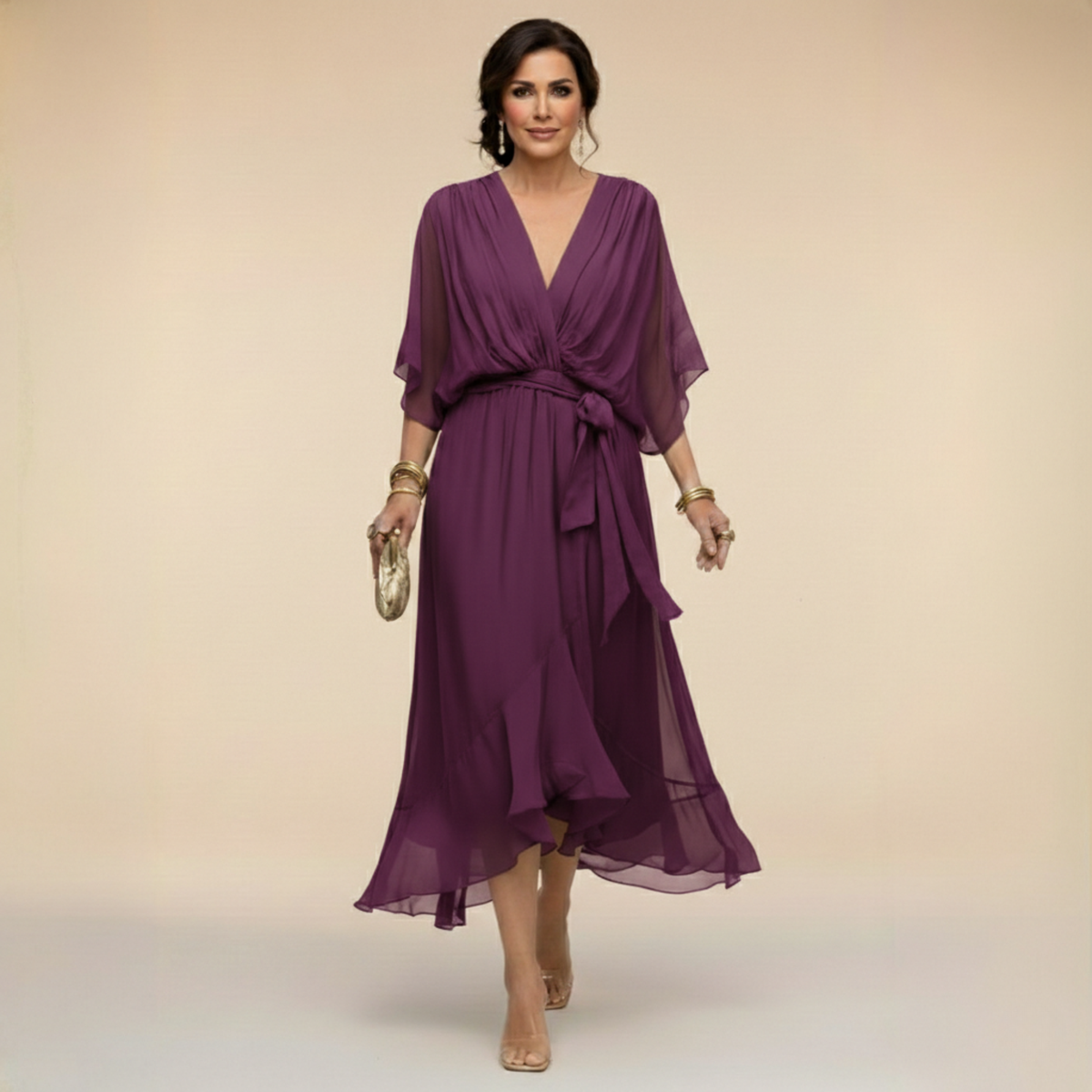 Model walking in the plum purple chiffon midi dress with wrap-effect V-neck, sheer sleeves, bow-tied waist and ruffled flowing hem. 9