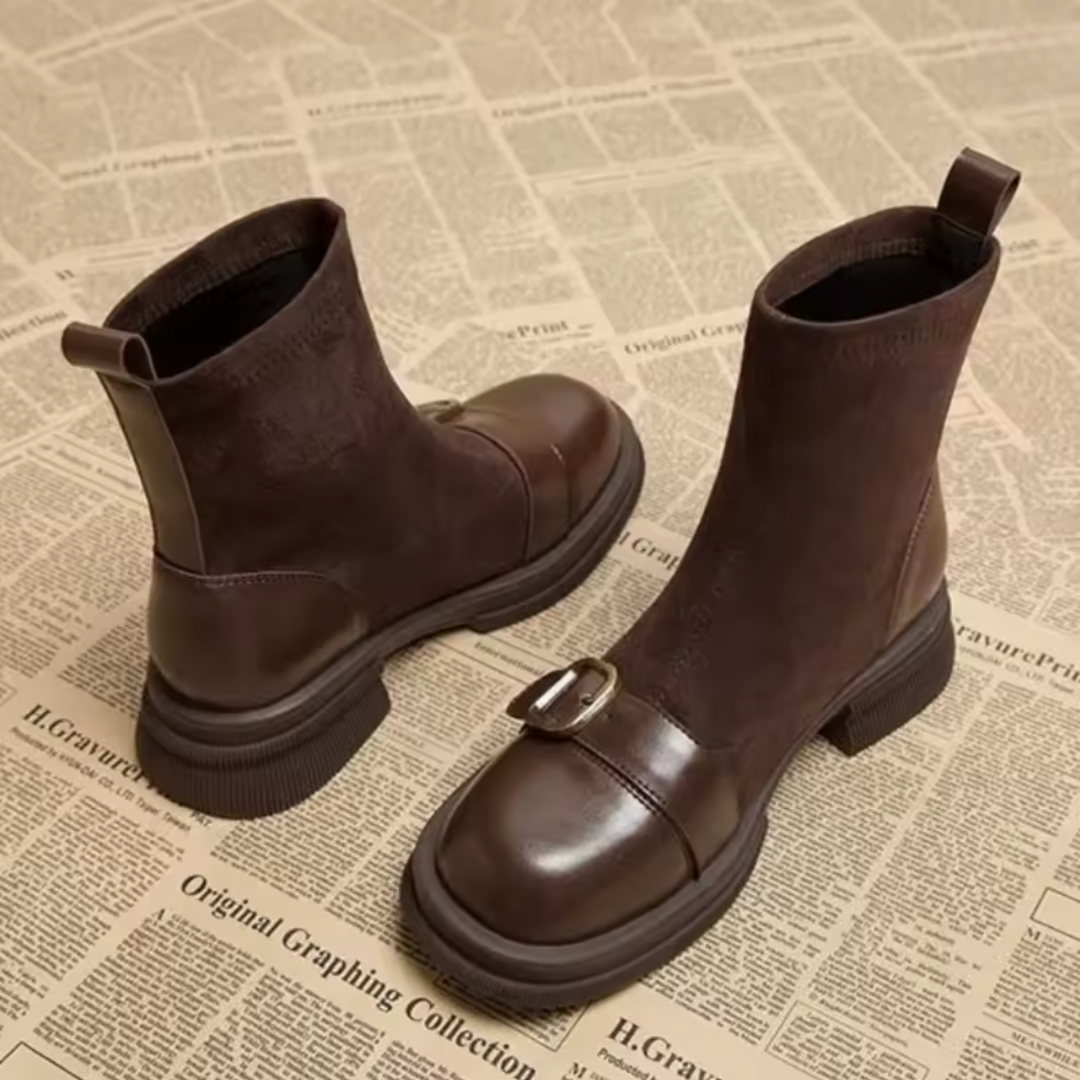 Pair of brown suede and leather ankle boots seen from the back and side, showing the pull tab, leather heel panel and chunky sole. 2
