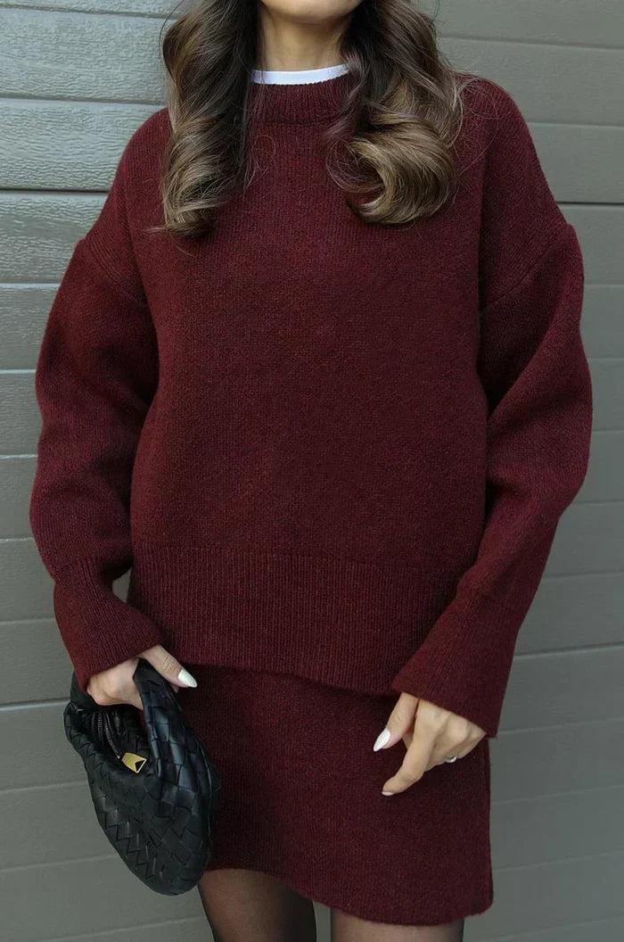 Close-up of the burgundy sweater's ribbed hem and cuffs with the matching skirt below 4
