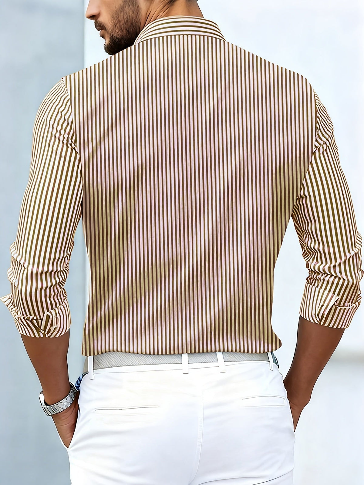 Back view of the brown and cream striped shirt on a model, showing plain vertical stripes across the back and sleeves. 6