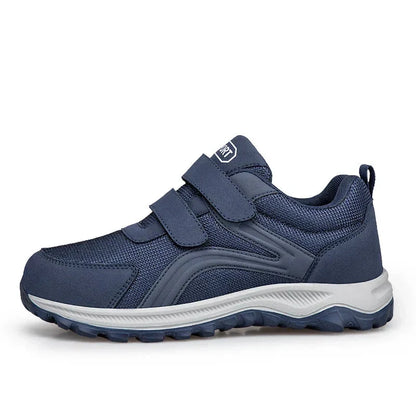 Navy strap shoe seen in side profile on a white background, showing the grey and navy sole 13