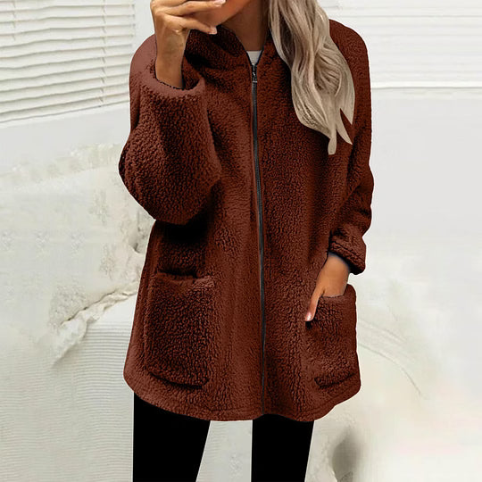 Model wearing the zipped fluffy fleece jacket in deep reddish brown with black leggings, hand in a pocket 6
