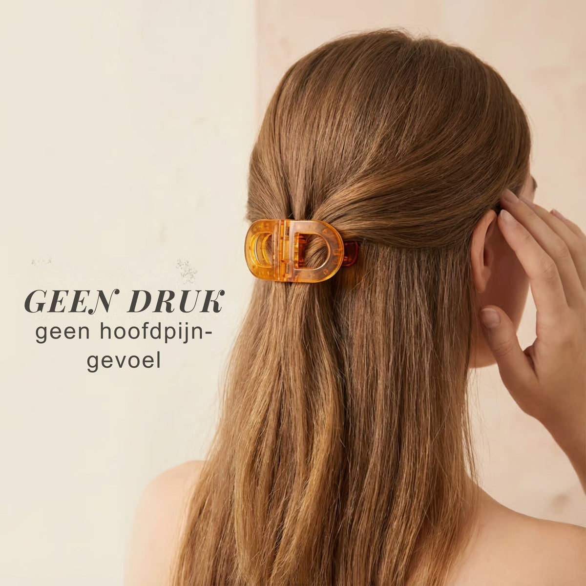 Woman seen from behind wearing the amber flat clip low on her head, one hand touching her ear, hair worn half up. 8